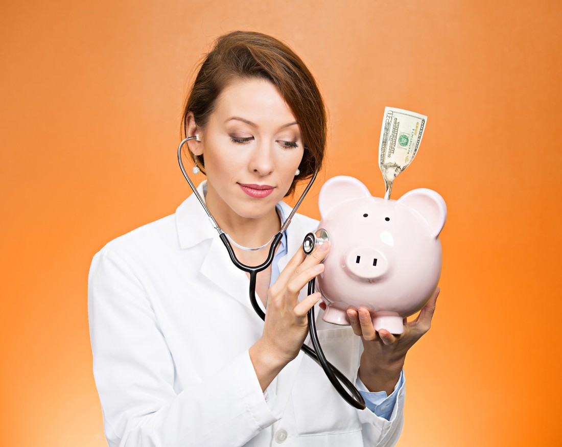 stethoscope doctor and piggy bank